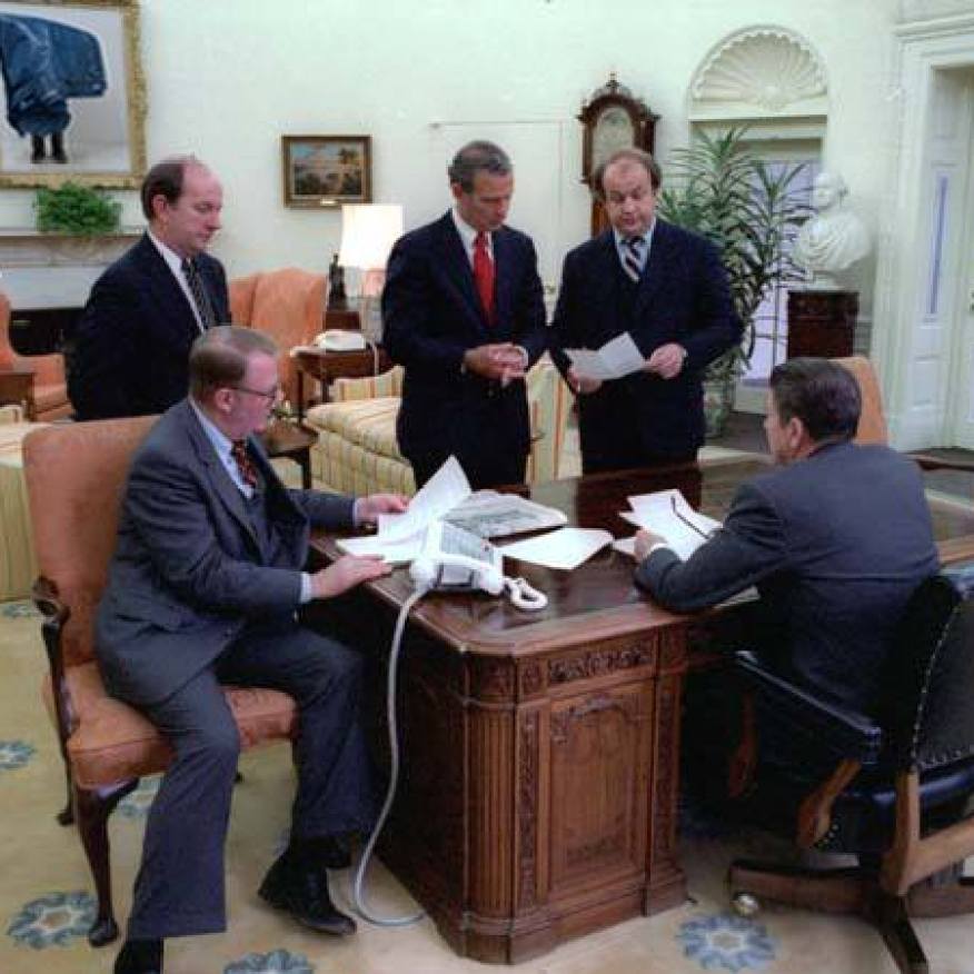 President Reagan holds an oval office staff meeting on his first full day in office (from left to right) Deputy Chief of Staff Michael Deaver, Counselor to the President Ed Meese, Chief of Staff James Baker III, Press Secretary James Brady, President Reagan. 1/21/81. Digital Intervention 2013